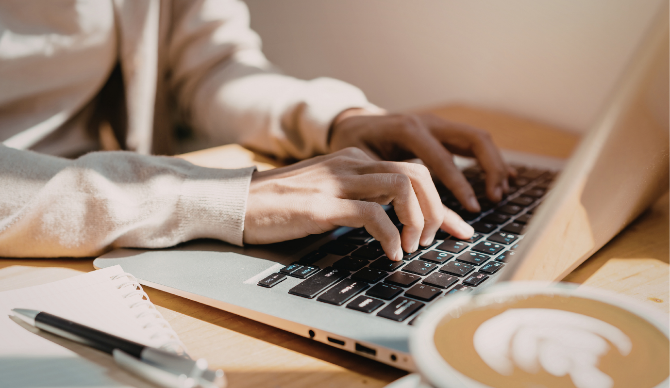Person working on linkedin profile on laptop with coffee