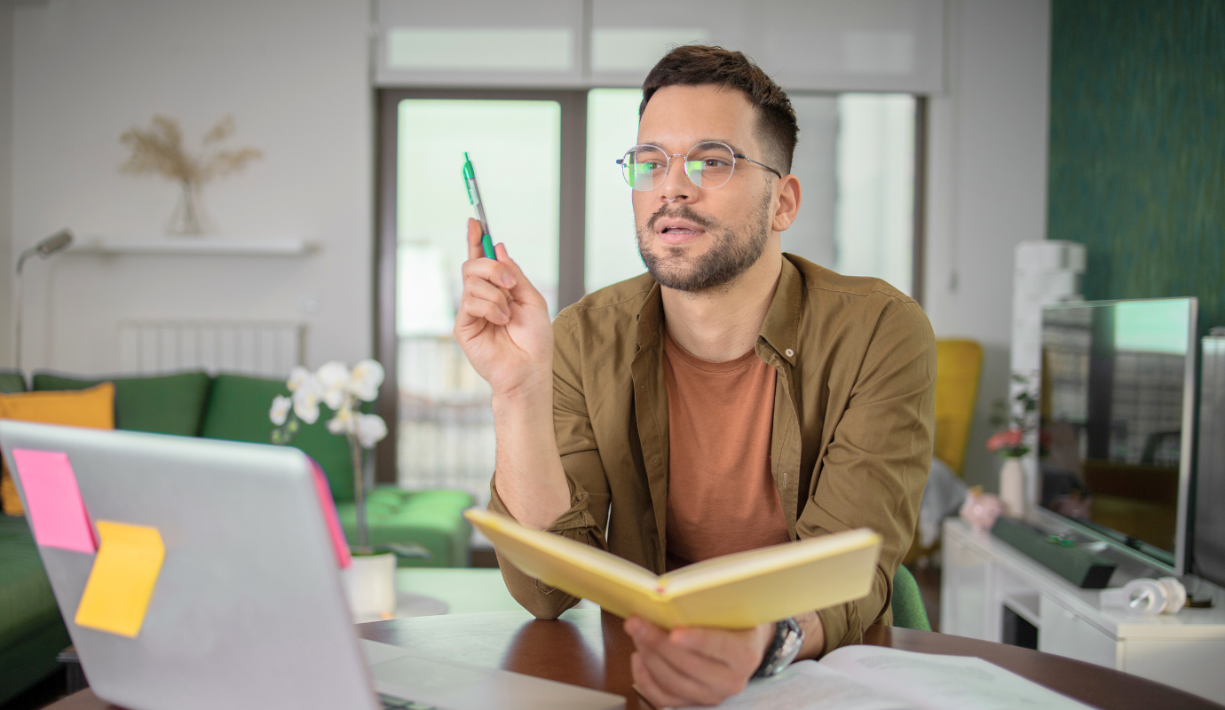 Person studying hard skills with a notebook and laptop.