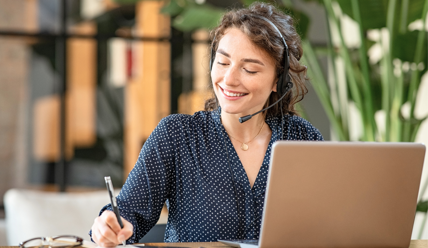 Smiling woman working in Customer Service with headset.