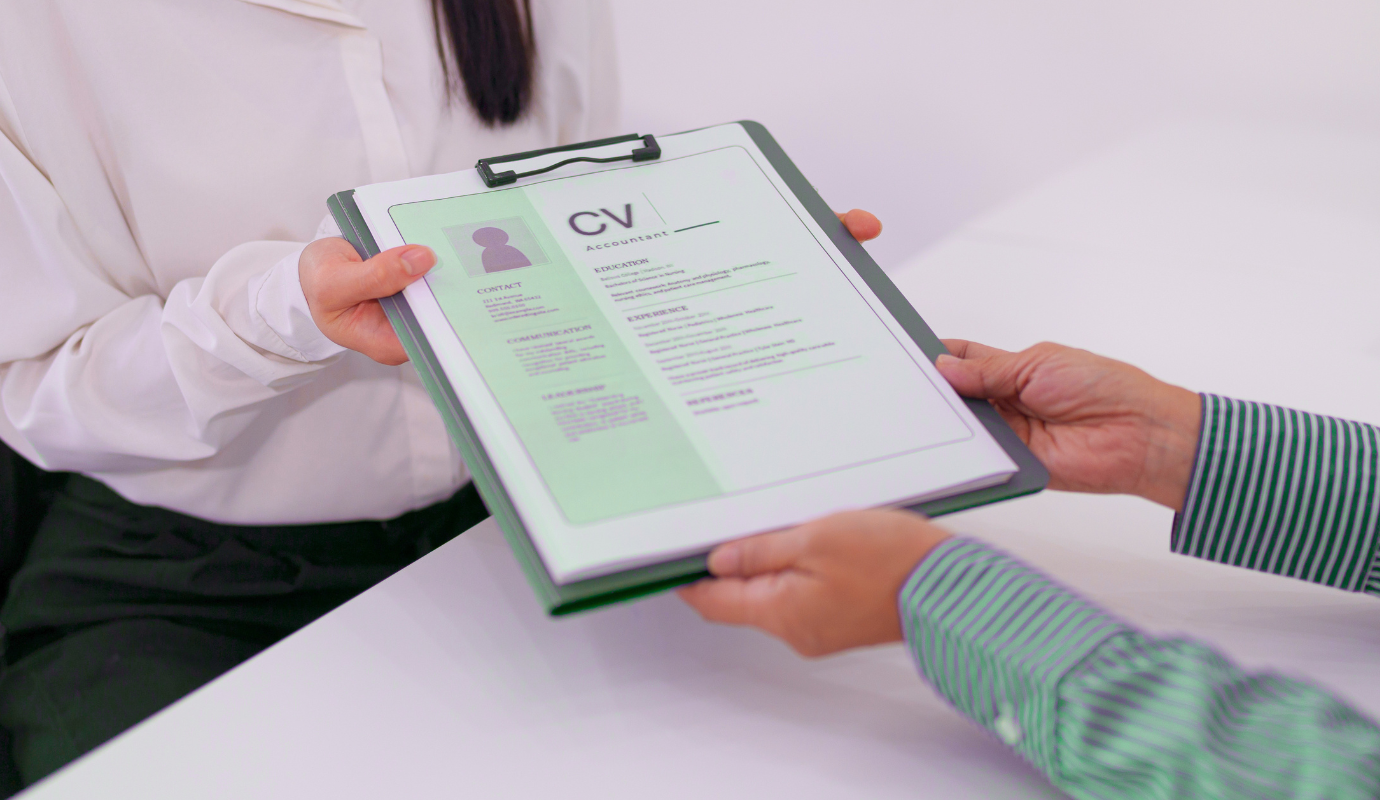 Person shows CV layout to another person.