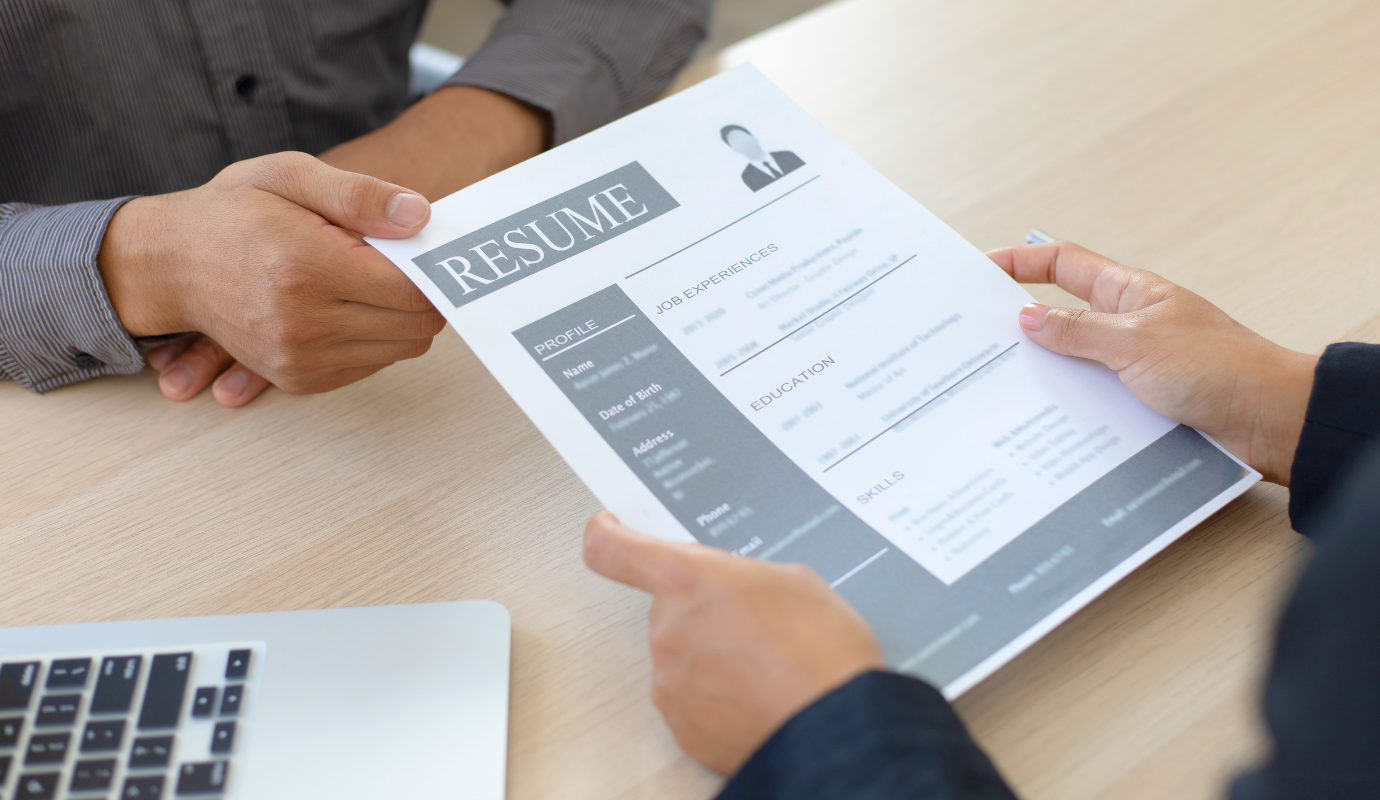 Person showing their CV layout to another person.