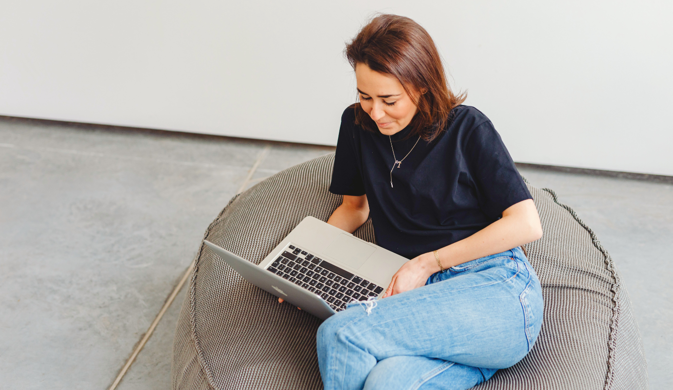 Women sitting on seat cushion working on her Interview Prep.